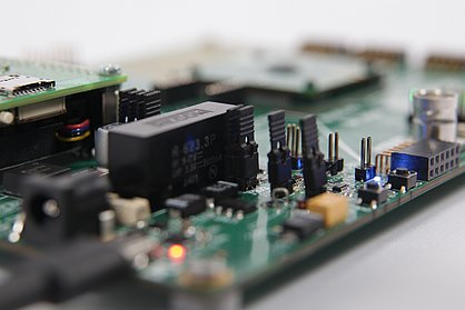 Printed circuit boards fitted with components and illuminated LEDs