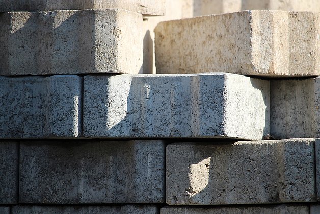 IMMS is developing a wireless vibration measurement system for lower-emission concrete block production. Photograph: FlorinBirjoveanu, Pixabay. stacked concrete blocks