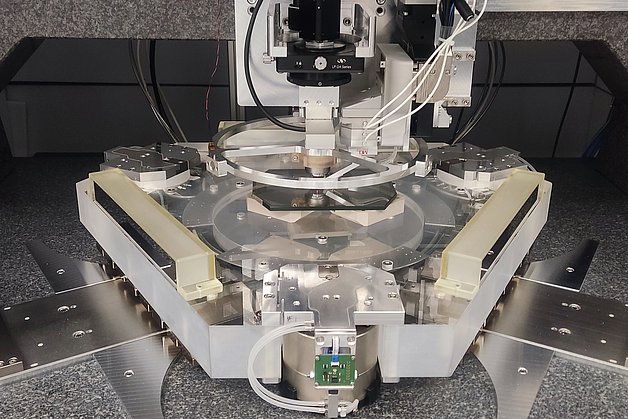 Complex construction of glass, metal, electronic and pneumatic components on a granite block.