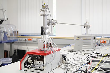 Set-up consisting of metal pipes, cables and measuring devices on a laboratory bench.