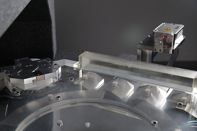 Close-up of the quartz glass slider with a metal lifting module, magnetic bridges and laser interferometer.