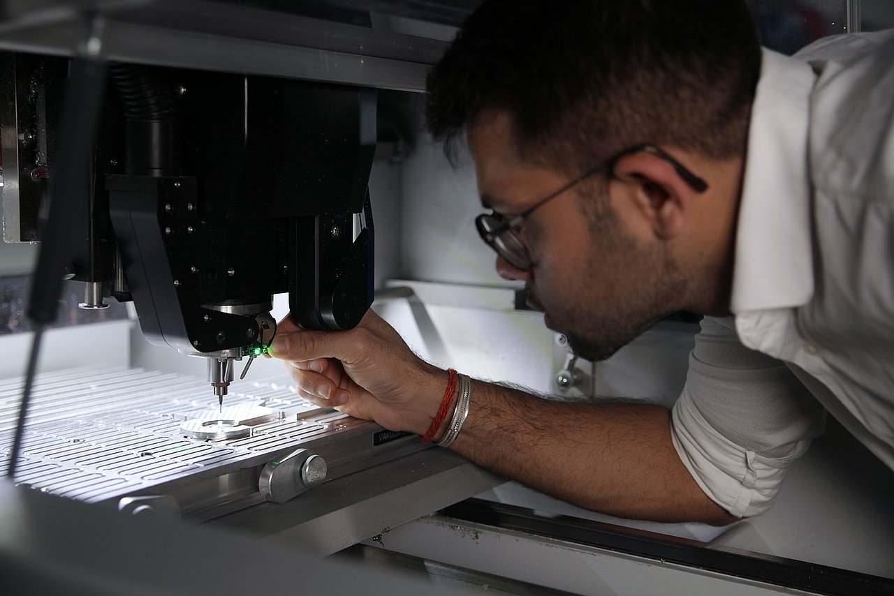 Rick Pandey with an AI-based embedded system for machine diagnosis. Edge AI systems like these are being researched in terms of their energy efficiency and overall system energy modelling in the HoLoDEC project. Photograph: IMMS.